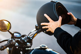 Man holding helmet before mounting motorcycle