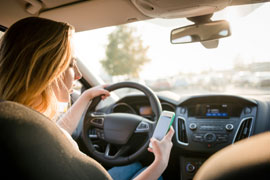 Woman texting on phone while driving
